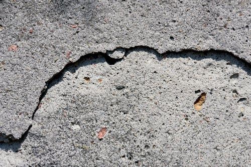 Close-up of a spalled and cracked concrete surface awaiting repair
