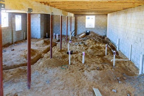 Concrete foundation stem walls and footings on an active construction site